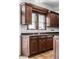 Kitchen features dark wood cabinets, granite countertops, and a large window at 814 E 23Rd St, Indianapolis, IN 46205