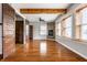 Spacious living room featuring hardwood floors, a stone fireplace, and large windows at 814 E 23Rd St, Indianapolis, IN 46205