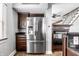 Stainless steel refrigerator in kitchen with dark wood cabinets at 814 E 23Rd St, Indianapolis, IN 46205