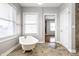Bathroom with clawfoot tub and view into living room at 814 E 23Rd St, Indianapolis, IN 46205