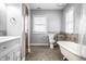 Updated bathroom with a clawfoot tub, tiled shower, and modern vanity at 814 E 23Rd St, Indianapolis, IN 46205