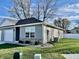 Gray house exterior with a white garage door and nicely landscaped yard at 1441 Coen Ct, Columbus, IN 47201