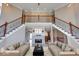 Spacious living room featuring a double staircase and a cozy fireplace at 1957 Cherry Tree Rd, Avon, IN 46123