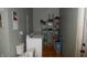 Laundry room with washer, dryer, and storage shelves at 7716-7718 Michigan Rd, Indianapolis, IN 46268