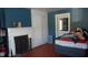 Bedroom with fireplace, built-ins, and hardwood floors at 7716-7718 Michigan Rd, Indianapolis, IN 46268