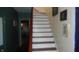 White and wood staircase with a slight curve at 7716-7718 Michigan Rd, Indianapolis, IN 46268