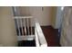 Upper hallway with hardwood floors and white railing at 7716-7718 Michigan Rd, Indianapolis, IN 46268