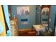 Bathroom with pedestal sink and beach-themed art at 7716-7718 Michigan Rd, Indianapolis, IN 46268