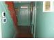 Long hallway with green walls, wood floors, and staircase at 7716-7718 Michigan Rd, Indianapolis, IN 46268