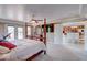 Main bedroom with a king-size bed, and a view into the kitchen and dining area at 1957 Cherry Tree Rd, Avon, IN 46123