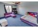 Bedroom with purple bed, sectional sofa, and a ceiling fan at 1957 Cherry Tree Rd, Avon, IN 46123