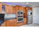 Modern kitchen featuring stainless steel appliances and dark wood cabinetry at 1957 Cherry Tree Rd, Avon, IN 46123