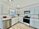 Modern kitchen with white cabinets, stainless steel appliances, and marble countertops at 1441 Coen Ct, Columbus, IN 47201