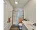 Modern bathroom with a walk-in shower and gray wood-look floors at 1441 Coen Ct, Columbus, IN 47201