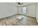 Bright bedroom featuring wood-look floors and a window with blinds at 1441 Coen Ct, Columbus, IN 47201