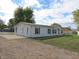 White single story home with a gravel driveway at 353 E Sycamore St, Morgantown, IN 46160