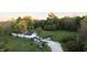 Aerial view of a house with a yard and driveway, surrounded by trees at 3231 W State Road 32, Westfield, IN 46074