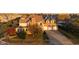 Brick house with 3-car garage, large yard, and mature trees. Golden hour lighting at 7189 Lockford N, Avon, IN 46123