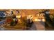 Brick house with 3-car garage, large yard, and mature trees. Golden hour lighting at 7189 Lockford N, Avon, IN 46123