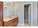 Bathroom with wood vanity, large mirror, and access to a separate room at 7189 Lockford N, Avon, IN 46123