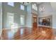 Sunlit living room with hardwood floors, high ceilings, and views of dining area at 7189 Lockford N, Avon, IN 46123