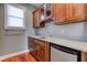 Wet bar with wood cabinets, granite countertop, and mini-fridge at 7189 Lockford N, Avon, IN 46123