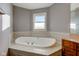 Bathroom with corner bathtub, double vanity and window at 7189 Lockford N, Avon, IN 46123