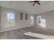 Main bedroom with tray ceiling, carpet, and multiple windows at 7189 Lockford N, Avon, IN 46123