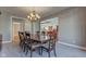 Spacious dining room with large table and chandelier, hardwood floors, and view into the living room at 7189 Lockford N, Avon, IN 46123