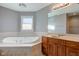 Bathroom with corner bathtub, double vanity, and window at 7189 Lockford N, Avon, IN 46123