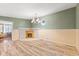Dining room with corner fireplace, wood-look floors, and chandelier at 1912 N A St, Elwood, IN 46036