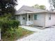 Tan house with white porch and well-maintained landscaping at 309 S Fleming St, Indianapolis, IN 46241