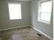 Bright bedroom with two windows and wood-look flooring at 309 S Fleming St, Indianapolis, IN 46241