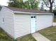Detached single car garage with white door and light beige vinyl siding at 309 S Fleming St, Indianapolis, IN 46241