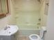 Clean bathroom with a tub, shower, toilet, and vanity at 309 S Fleming St, Indianapolis, IN 46241