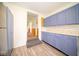 Kitchen with light blue cabinets and stainless steel appliances at 6063 W Mount Auburn 2Nd St, Edinburgh, IN 46124