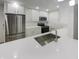 Modern kitchen with white cabinets, quartz countertops and stainless steel appliances at 926 Stockton St, Indianapolis, IN 46260