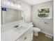 Updated bathroom with white vanity, quartz countertop, and subway tile shower at 926 Stockton St, Indianapolis, IN 46260
