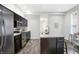 Updated kitchen featuring dark cabinetry and stainless steel appliances at 1007 Broadway St, Indianapolis, IN 46202