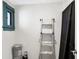 Unfinished basement with a ladder and paint supplies at 1007 Broadway St, Indianapolis, IN 46202