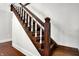 Elegant wooden staircase with carved detailing and white balusters at 1007 Broadway St, Indianapolis, IN 46202