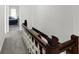 Upper hallway with carpeted floors and wooden staircase at 1007 Broadway St, Indianapolis, IN 46202