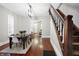 Bright dining room features hardwood floors, a charming wooden staircase, and an elegant chandelier at 1007 Broadway St, Indianapolis, IN 46202