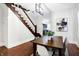 Bright dining room features hardwood floors, a charming wooden staircase, and an elegant chandelier at 1007 Broadway St, Indianapolis, IN 46202