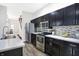 Modern kitchen with dark cabinetry and stainless steel appliances at 1007 Broadway St, Indianapolis, IN 46202
