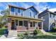 Blue and yellow two-story house with a brick porch at 1007 Broadway St, Indianapolis, IN 46202