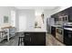 Eat-in kitchen with dark cabinetry, stainless steel appliances, and island at 1007 Broadway St, Indianapolis, IN 46202