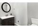 Small bathroom with dark vanity and a toilet at 1007 Broadway St, Indianapolis, IN 46202