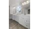 Bright bathroom with double vanity, white cabinets, and natural light at 230 Mcnair Rd, Whiteland, IN 46184