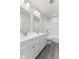 Bathroom with double vanity, tub, and grey floor at 230 Mcnair Rd, Whiteland, IN 46184